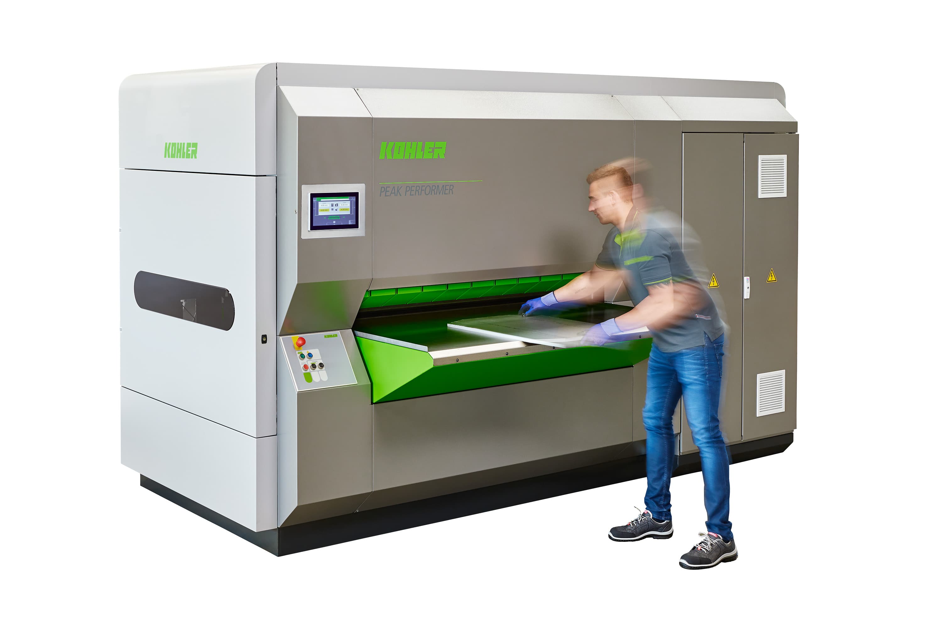 A KOHLER Peak Performer part levelling machine with an operator loading a blank